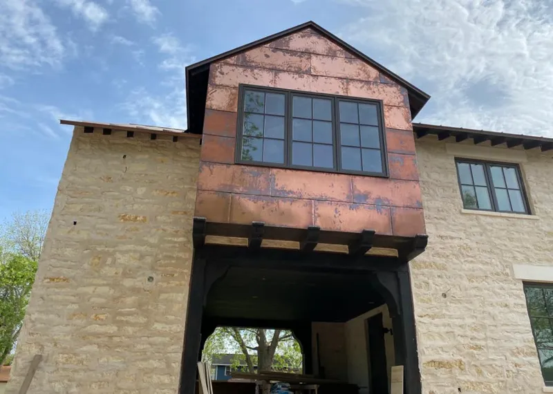 Copper metal panel facade on a stone building for Skylight Installation in Colesville